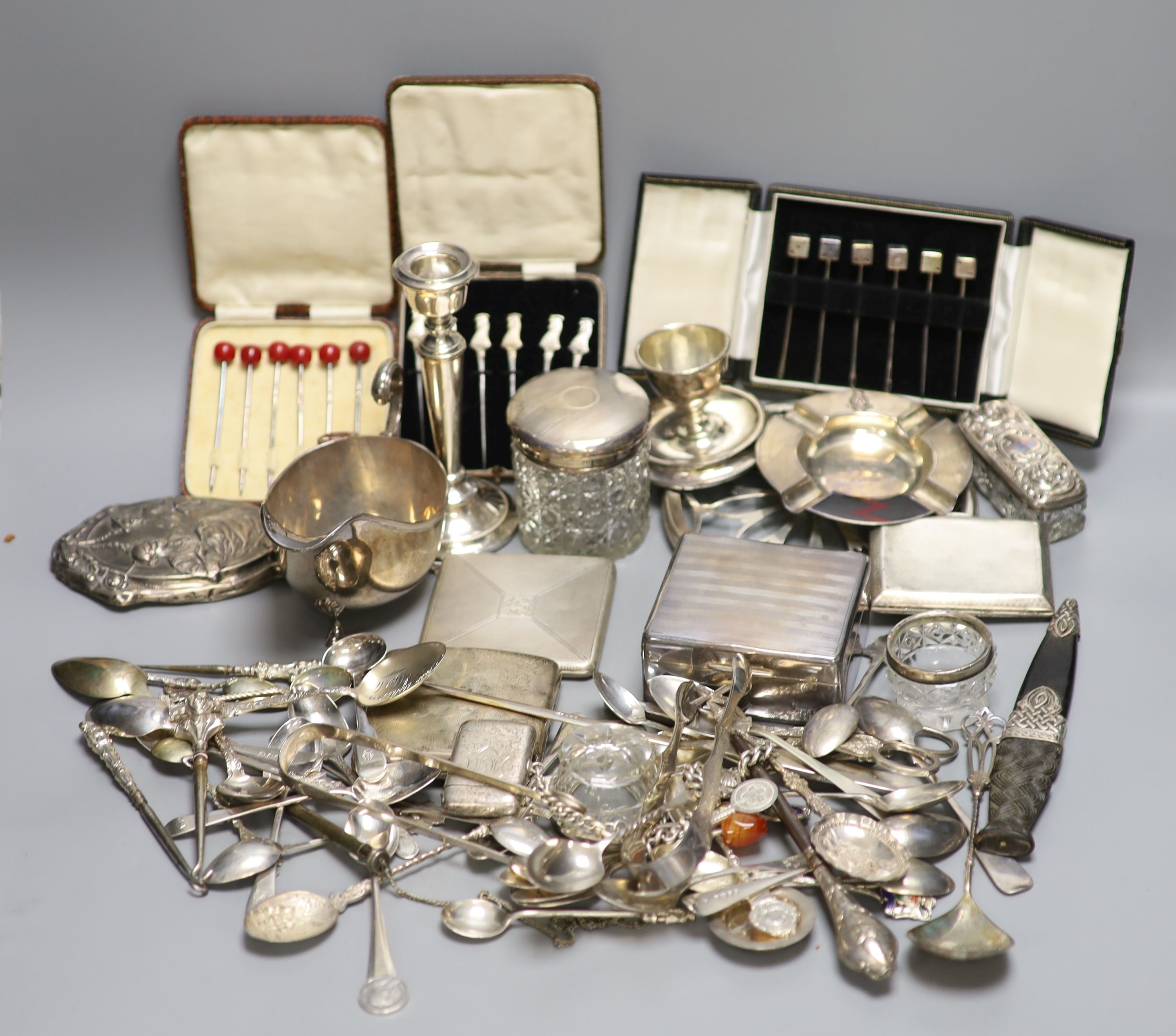 Assorted small silver including cased sets of cocktail sticks, sauceboat, toilet jars, cigarette box, cigarette cases and minor flatware etc.